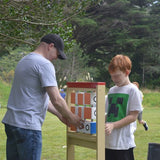 A young boy and his big buddy playing a game outside