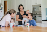 A young boy with autism with a group of adults and children