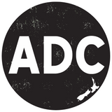 ADC logo - white wording ADC on black with NZ map