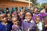 A group of smiling children receiving aid from ChildFund