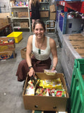 A volunteer packs groceries at Auckland City Mission